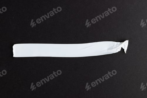 Preview: Ripped up piece of white tape with copy space on black background