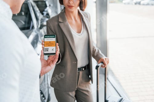 Preview: Woman showing her vaccine passport by using smartphone to the man