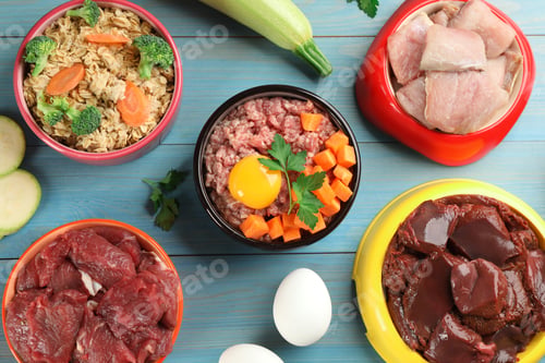 Preview: Pet food and natural ingredients on light blue wooden table, flat lay