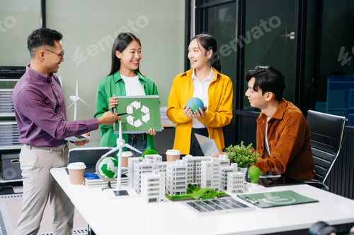 Preview: Group of diverse multiethnic businesspeople standing neare table looking at model of building from
