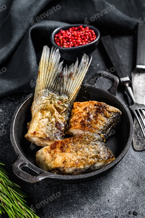 Preview: Grilled river fish silver carp. Black background. Top view