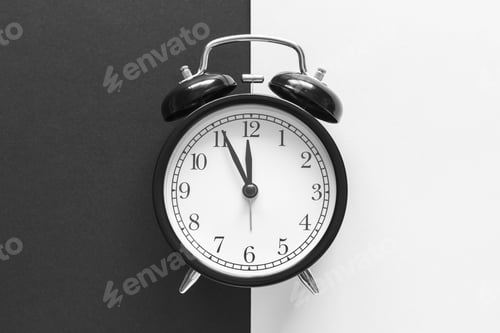 Preview: Classic alarm clock on black and white background. Time concept.