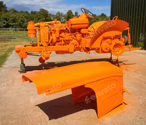 Preview: Tractor parts that have been sprayed orange