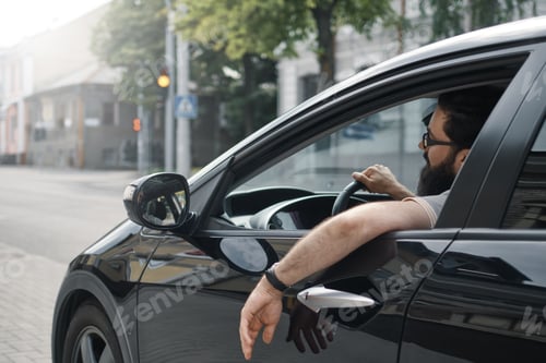Preview: Confident man driving a car