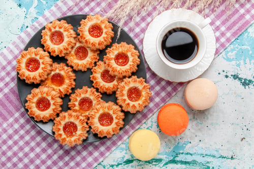Preview: top view delicious little cookies with french macarons and coffee on blue desk cookie biscuit sweet