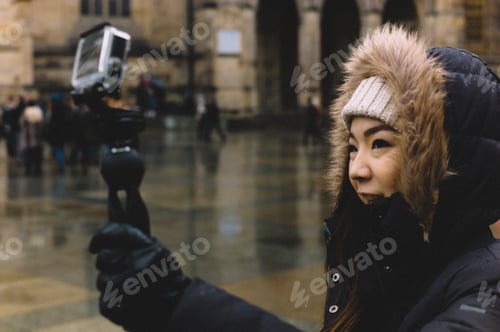 Preview: Woman taking selfie with action cam