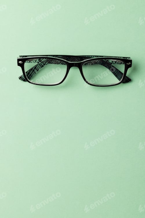 Preview: Vertical composition of glasses on green background with copy space