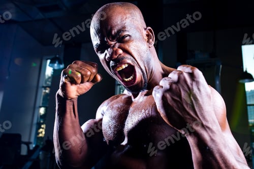 Preview: handsome shirtless latino american athlete male fight screaming in gym