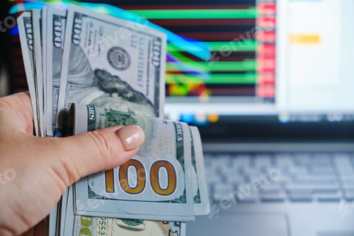 Preview: dollars bills and woman hand against the background of screen