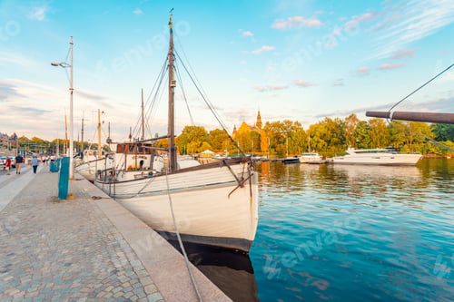 Preview: Boat anchored on Strandvägen with Djurgarden and Nordic museum in the background, Stockholm