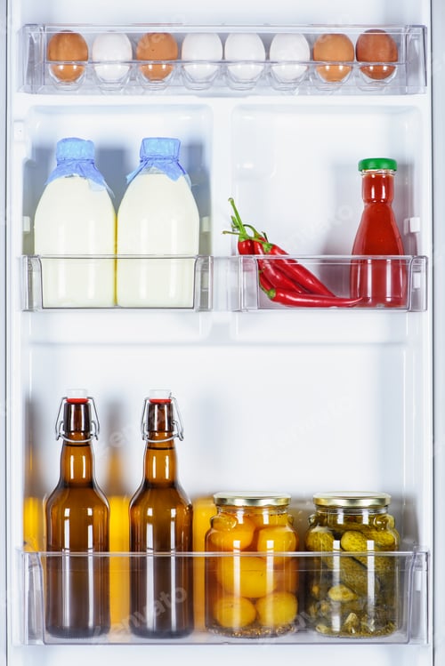 Preview: eggs, bottles of milk and preserved vegetables in fridge