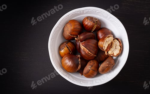 Preview: Roasted chestnuts on dark wooden background