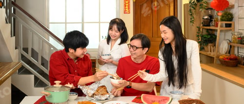 Preview: Happy family sharing a traditional Chinese New Year meal.