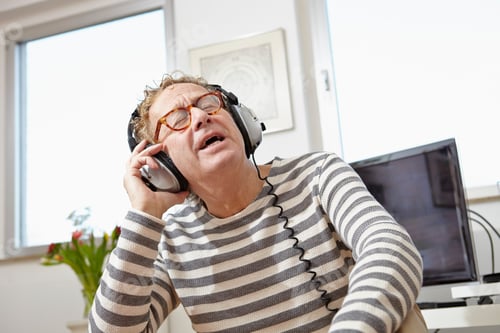 Preview: Senior man wearing headphones, listening to music