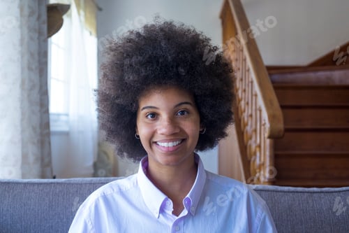 Preview: Portrait of smiling millennial attractive african american woman sitting on comfortable sofa