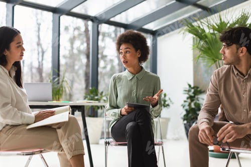Preview: Business Team Engaging In Teamwork And Focused Discussion In Office