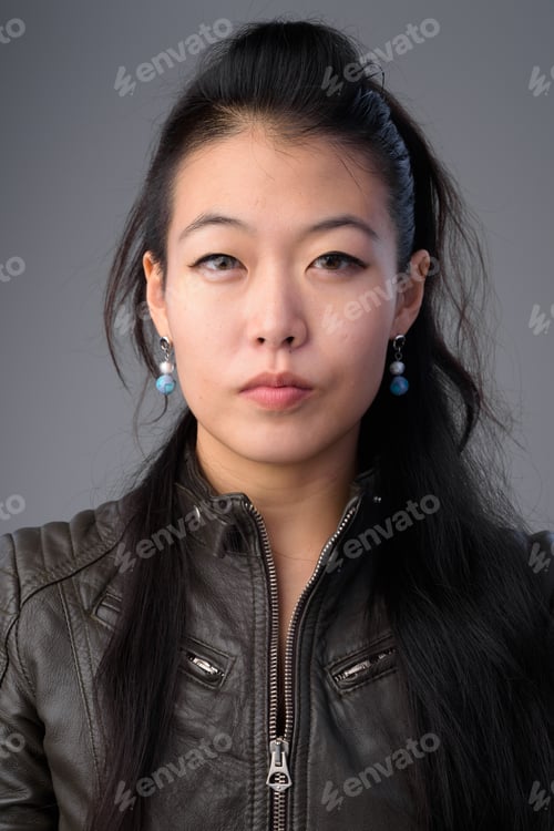 Preview: Face of beautiful Asian rebellious woman with leather jacket