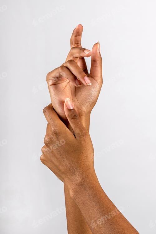 Preview: Unrecognizable black female hands touching in studio