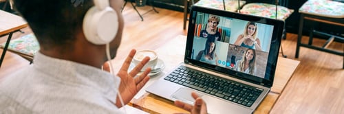 Preview: Man talking on video call with friends from a cafeteria