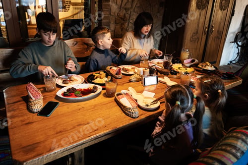 Preview: Family having a meal together in authentic ukrainian restaurant.