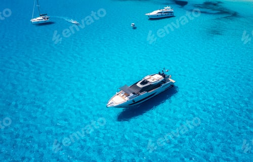 Preview: Aerial view of beautiful luxury yacht and sailboats in blue sea