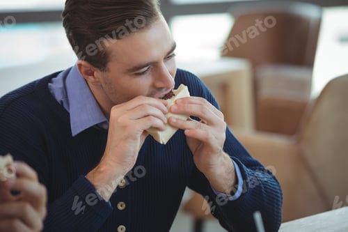 Preview: Businessman having breakfast at office cafeteria