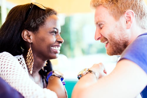 Preview: Romantic couple smiling while looking into each others eyes