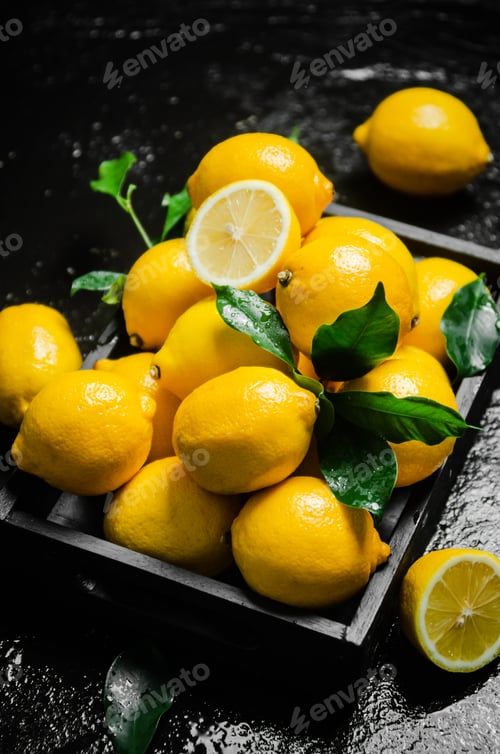 Preview: Fresh lemons. On black table.
