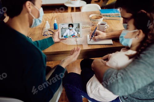 Preview: Close-up of black female doctor having video call with a family during coronavirus pandemic.