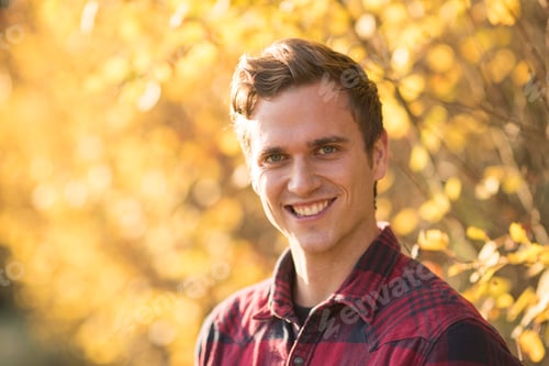 Preview: Portrait of young man outdoors, in rural setting