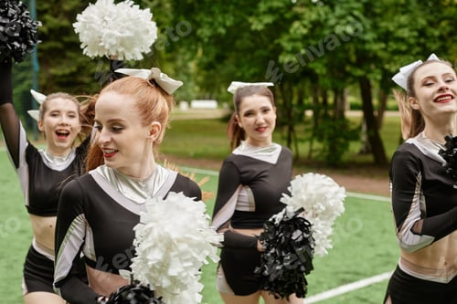 Preview: Group of cheerleading girls dancing outdoors