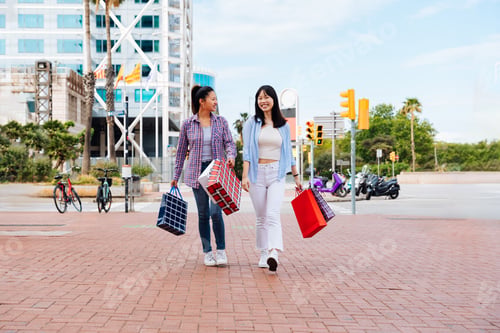 Preview: Happy beautiful chinese women friends bonding in the city