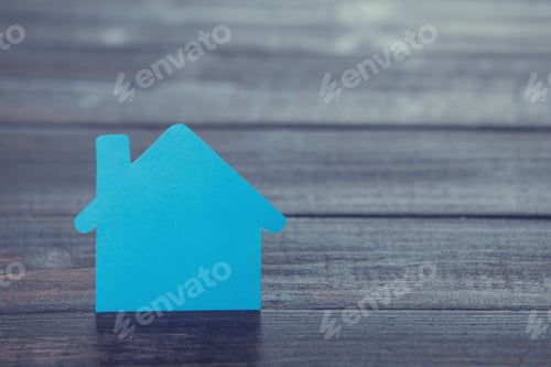 Preview: Paper house on wooden table.
