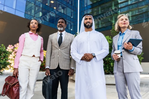 Preview: Group of multiethnic business people meeting an emirati businessman
