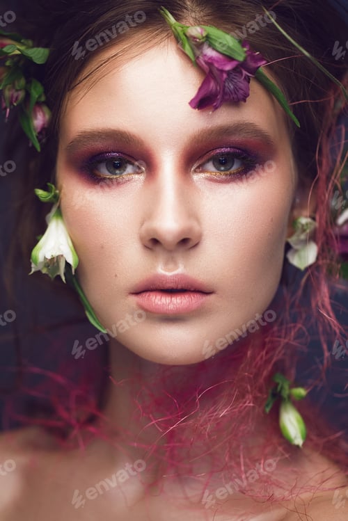 Preview: Beautiful girl with art make-up and flowers. beauty face.