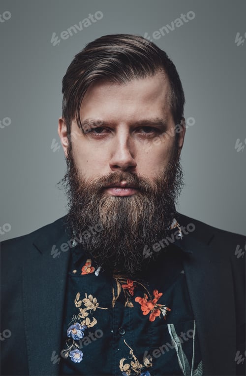 Preview: Portrait of a bearded and attractive hipster person in gray background