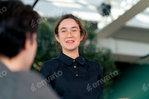 Preview: waitress girl taking orders from guests concept hospitality service in high class restaurant