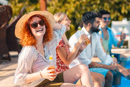 Preview: Group of friends having fun at summer vacation enjoying at poolside party.