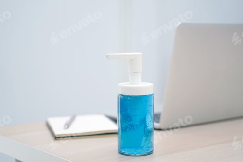 Vista previa: Workspace desk of computer laptop with alcohol sanitizer gel