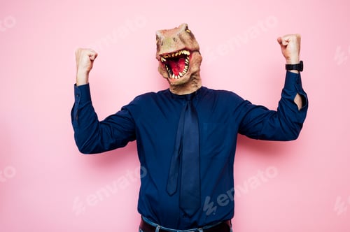 Preview: Euphoric man with dinosaur head with raised fists