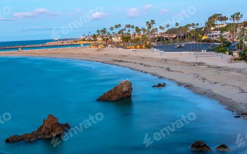 Preview: Aerial shot of a coastal resort town and pieces of rocky in the blue sea in summer