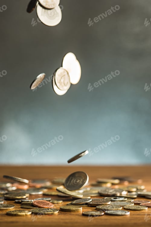 Preview: The silver and golden coins and falling coins on wooden background