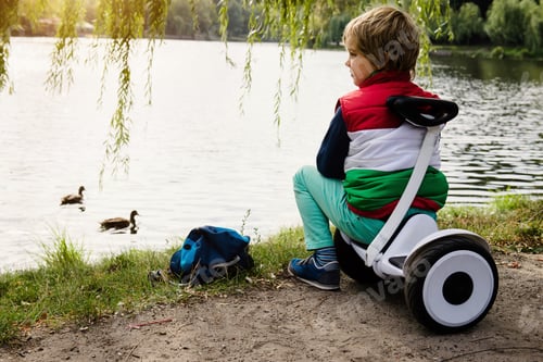 Preview: Boy on his new electronic hoverboard in the city outdoors