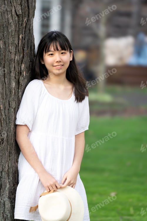 Preview: Portrait of a girl teen smiling lean against tree