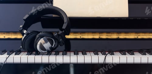 Preview: Headphones on piano keyboard, front view