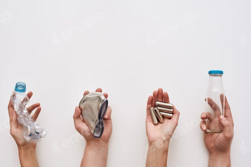 Preview: Sparate your trash. Four types of garbage in human hands