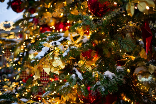 Preview: beautiful multi-colored toys on a Christmas tree against the background of lights and snow