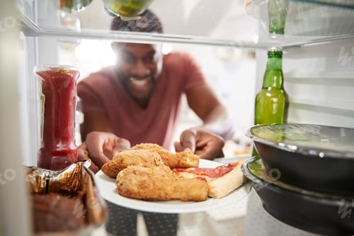 Preview: View Looking Out From Inside Of Refrigerator Filled With Unhealthy Takeaway Food As Man Opens Door