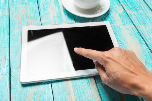 Preview: digital tablet and coffee cup on wooden table