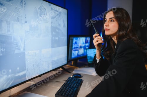 Preview: Security officer using walkie talkie monitoring surveillance system